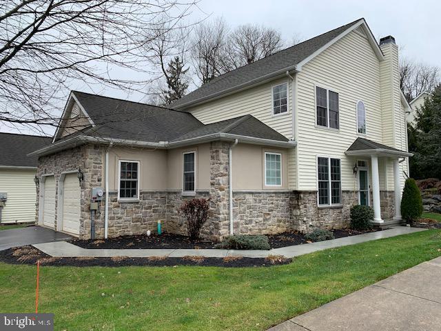 view of home's exterior featuring a garage and a yard