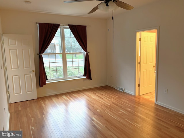 empty room featuring ceiling fan and light hardwood / wood-style floors