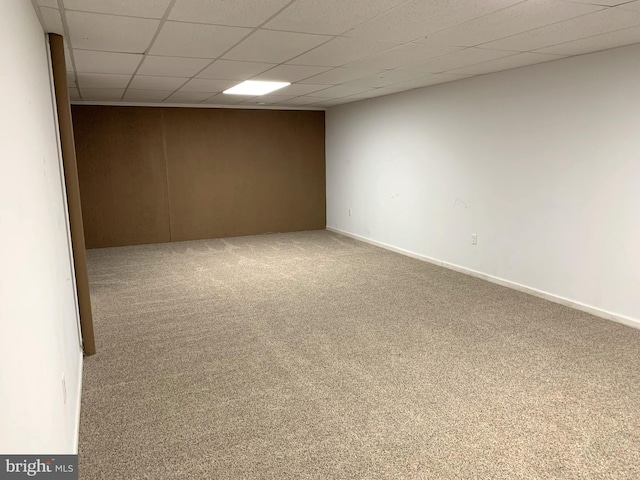 unfurnished room featuring carpet flooring and a drop ceiling