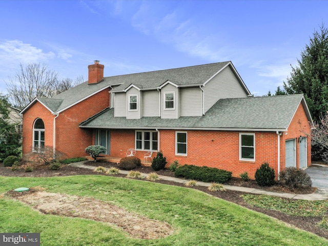 front of property featuring a front lawn and a garage