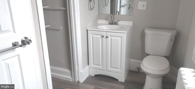 bathroom featuring hardwood / wood-style floors, vanity, toilet, and radiator