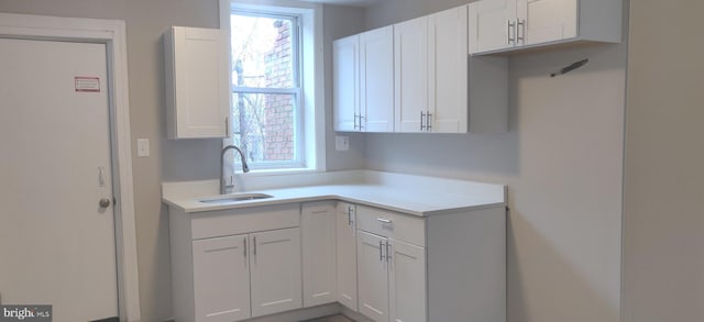 kitchen featuring white cabinetry, sink, and a healthy amount of sunlight