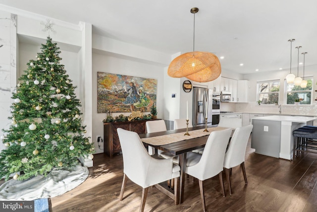 dining area with dark hardwood / wood-style floors and sink