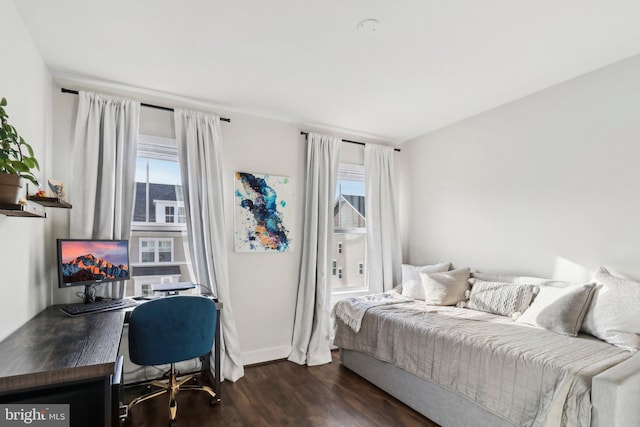 bedroom with dark wood-type flooring