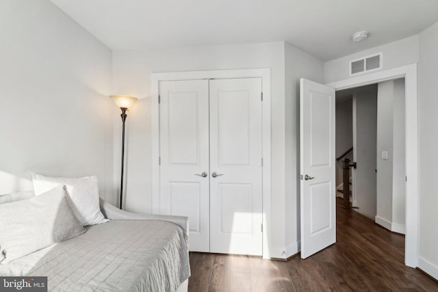 bedroom featuring dark hardwood / wood-style flooring and a closet