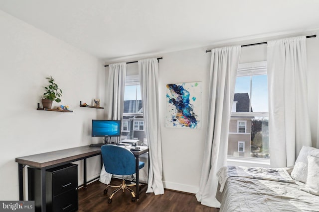 bedroom with dark hardwood / wood-style floors