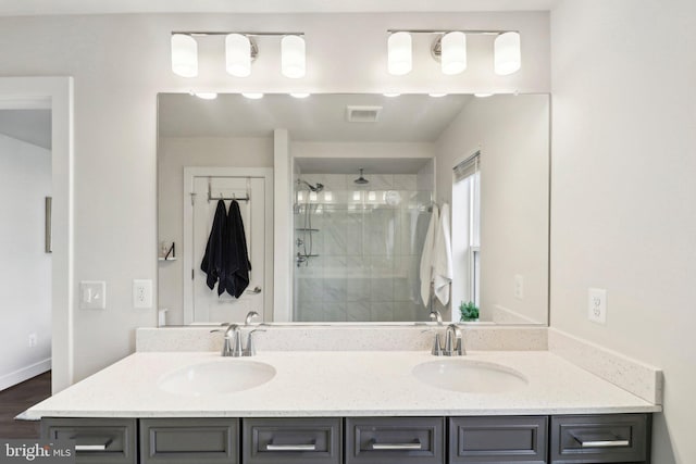 bathroom featuring vanity, hardwood / wood-style flooring, and a shower with door