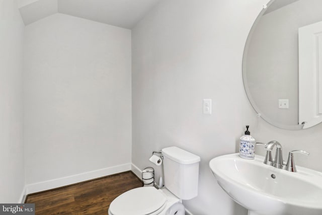 bathroom featuring wood-type flooring, toilet, and sink