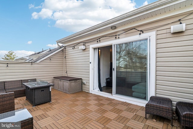 view of patio with an outdoor living space with a fire pit