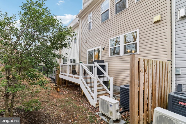 rear view of house with ac unit, cooling unit, and a wooden deck