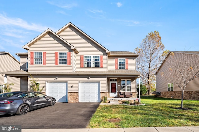 townhome / multi-family property with a front yard and a garage