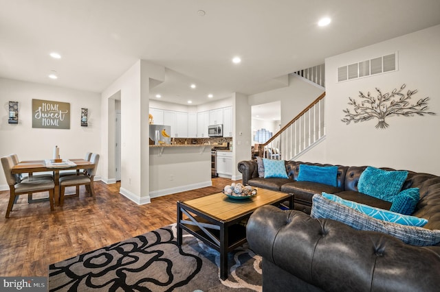 living room with dark hardwood / wood-style flooring