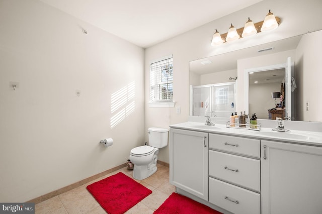 bathroom with tile patterned flooring, vanity, toilet, and a shower with shower door