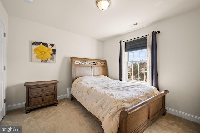 bedroom featuring light colored carpet