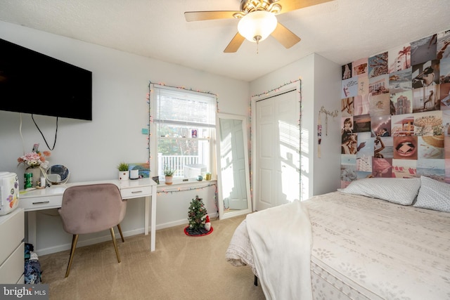 bedroom featuring carpet floors, ceiling fan, and built in desk