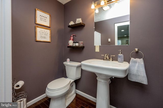 bathroom with wood-type flooring and toilet