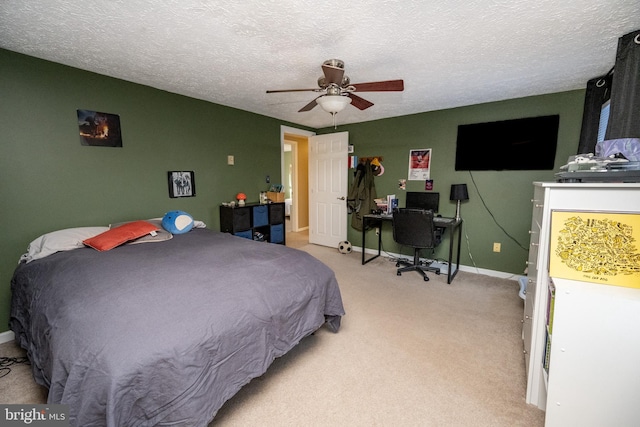 carpeted bedroom featuring a textured ceiling and ceiling fan