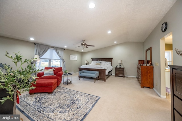 carpeted bedroom featuring ceiling fan, a textured ceiling, and vaulted ceiling