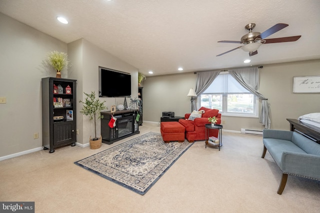 carpeted living room with ceiling fan, a baseboard radiator, and a textured ceiling