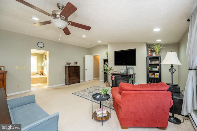 carpeted living room with ceiling fan, a textured ceiling, and vaulted ceiling