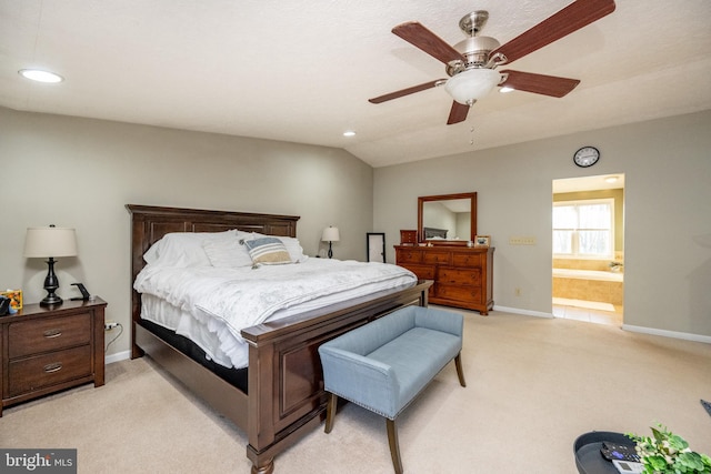 bedroom featuring light colored carpet, ensuite bath, ceiling fan, and lofted ceiling