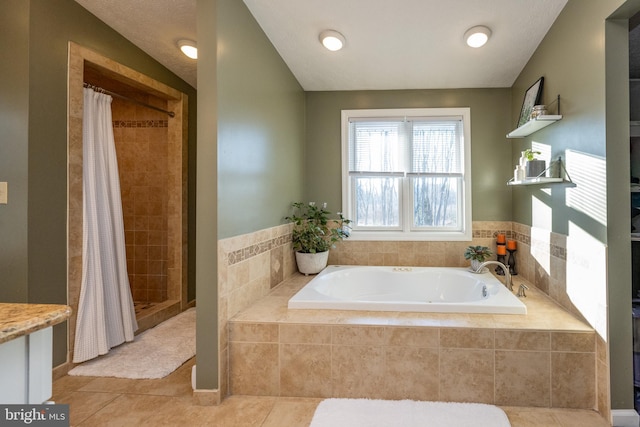 bathroom with tile patterned floors and shower with separate bathtub