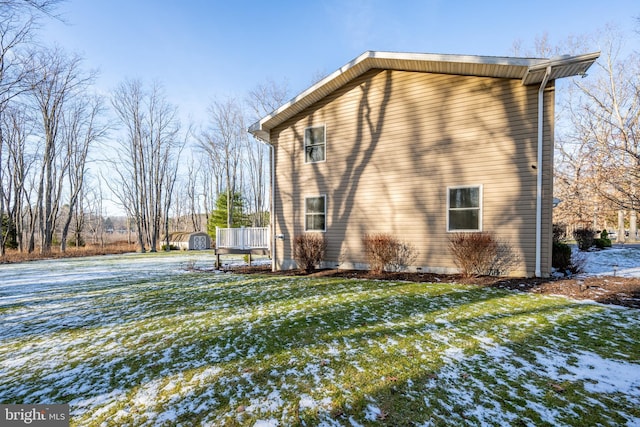 snow covered property with a yard