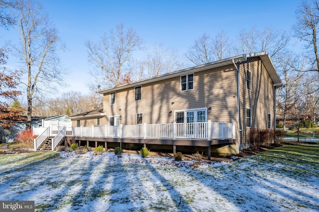 snow covered property with a deck