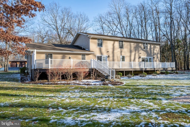 snow covered property with a lawn and a wooden deck