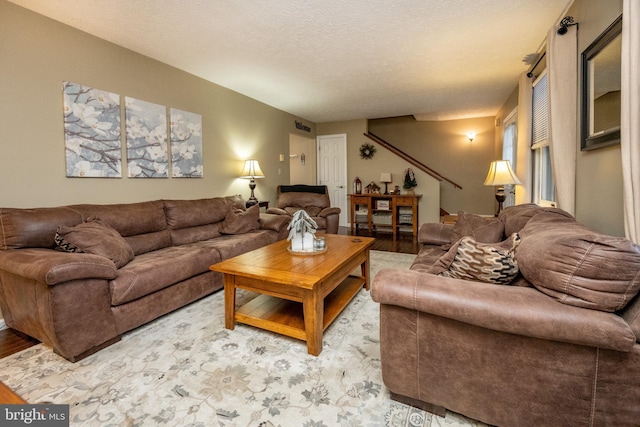 living room featuring hardwood / wood-style flooring and a textured ceiling