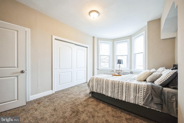 carpeted bedroom with a closet