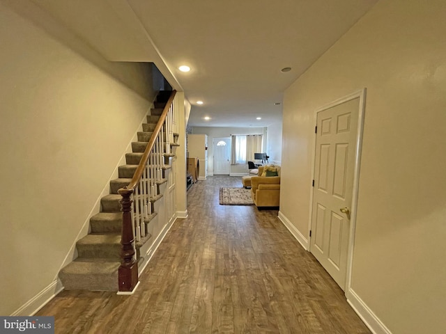 hall with dark hardwood / wood-style flooring