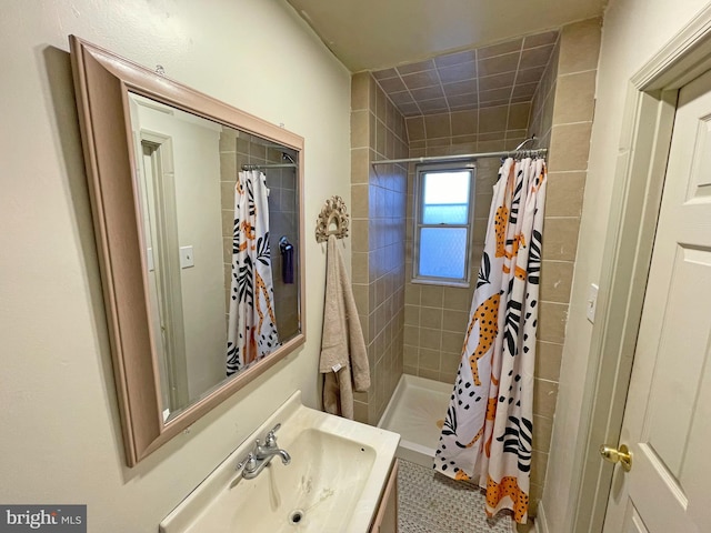 bathroom with curtained shower, tile patterned flooring, and vanity