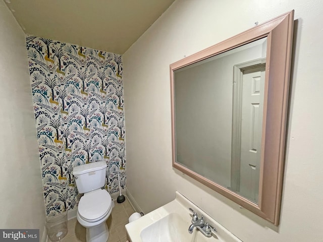 bathroom with sink, tile patterned flooring, and toilet