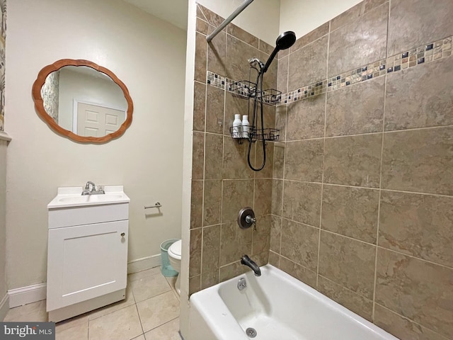 full bathroom featuring tile patterned flooring, vanity, toilet, and tiled shower / bath