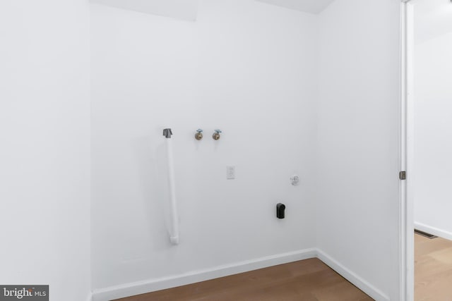 laundry room with wood-type flooring