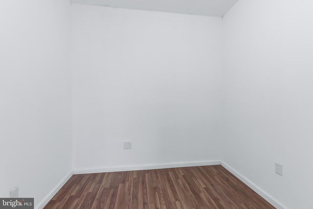 spare room with dark hardwood / wood-style flooring