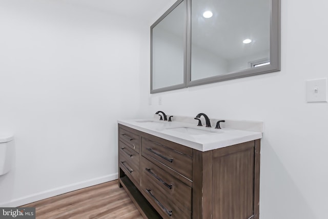 bathroom featuring hardwood / wood-style floors, vanity, and toilet