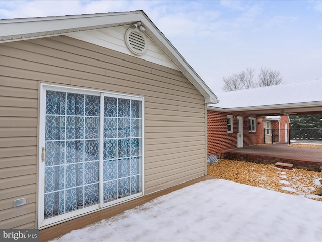 snow covered property featuring a patio area