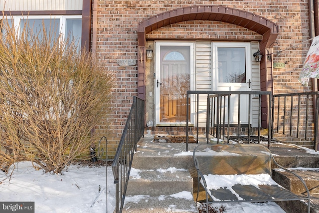 view of snow covered property entrance