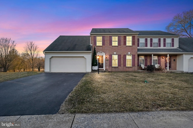 14 Limestone Ct, Lititz, PA 17543 - view of front of home with an attached garage, driveway, a yard, and brick siding