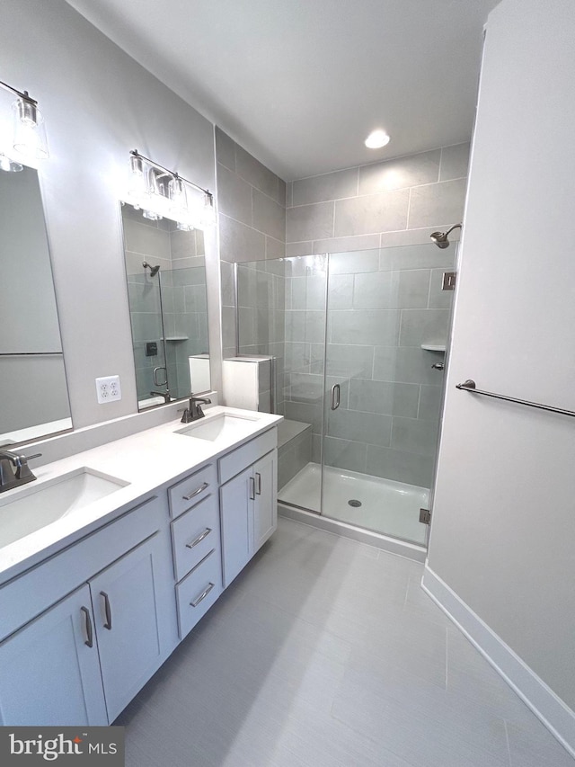 bathroom featuring tile patterned flooring, vanity, and an enclosed shower