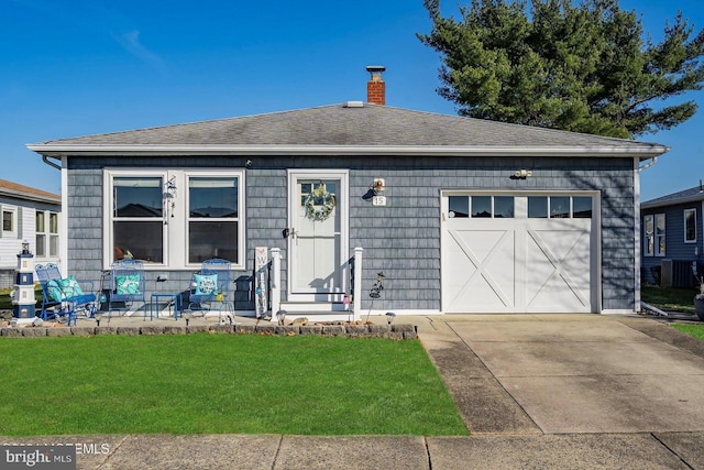 view of front of house with a garage and a front lawn