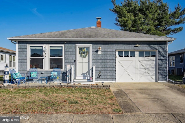 view of front of property with a front lawn and a garage