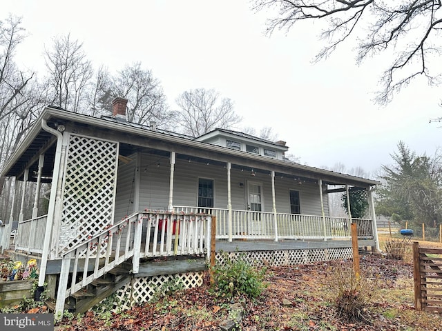 country-style home featuring covered porch