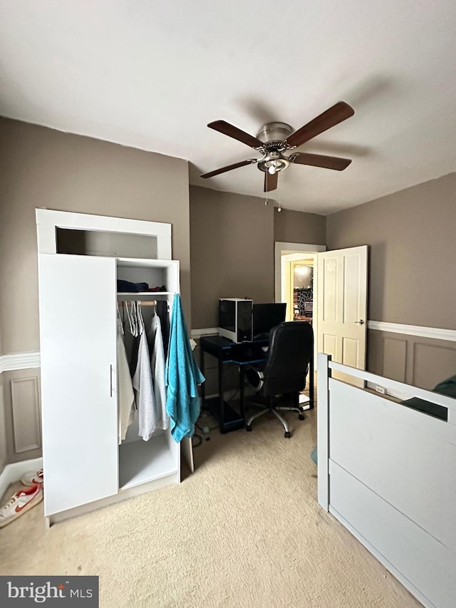 carpeted bedroom featuring a closet and ceiling fan