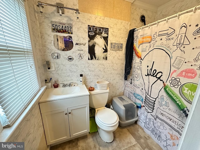 bathroom featuring ornamental molding, vanity, tile walls, toilet, and curtained shower