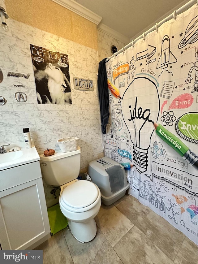 bathroom with vanity, toilet, and crown molding