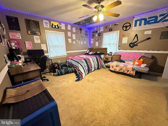 carpeted bedroom featuring multiple windows and ceiling fan