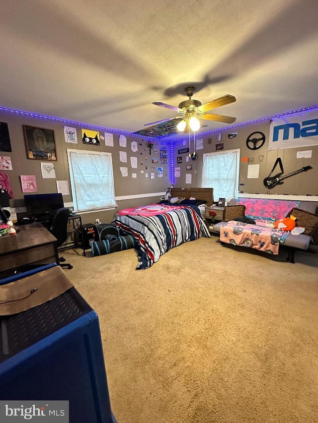 carpeted bedroom featuring ceiling fan and multiple windows